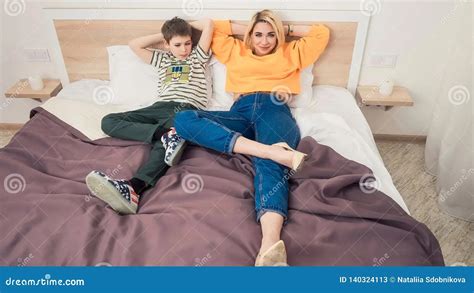 in bed with stepmom|Step mommy and stepson share a bed in a hotel room